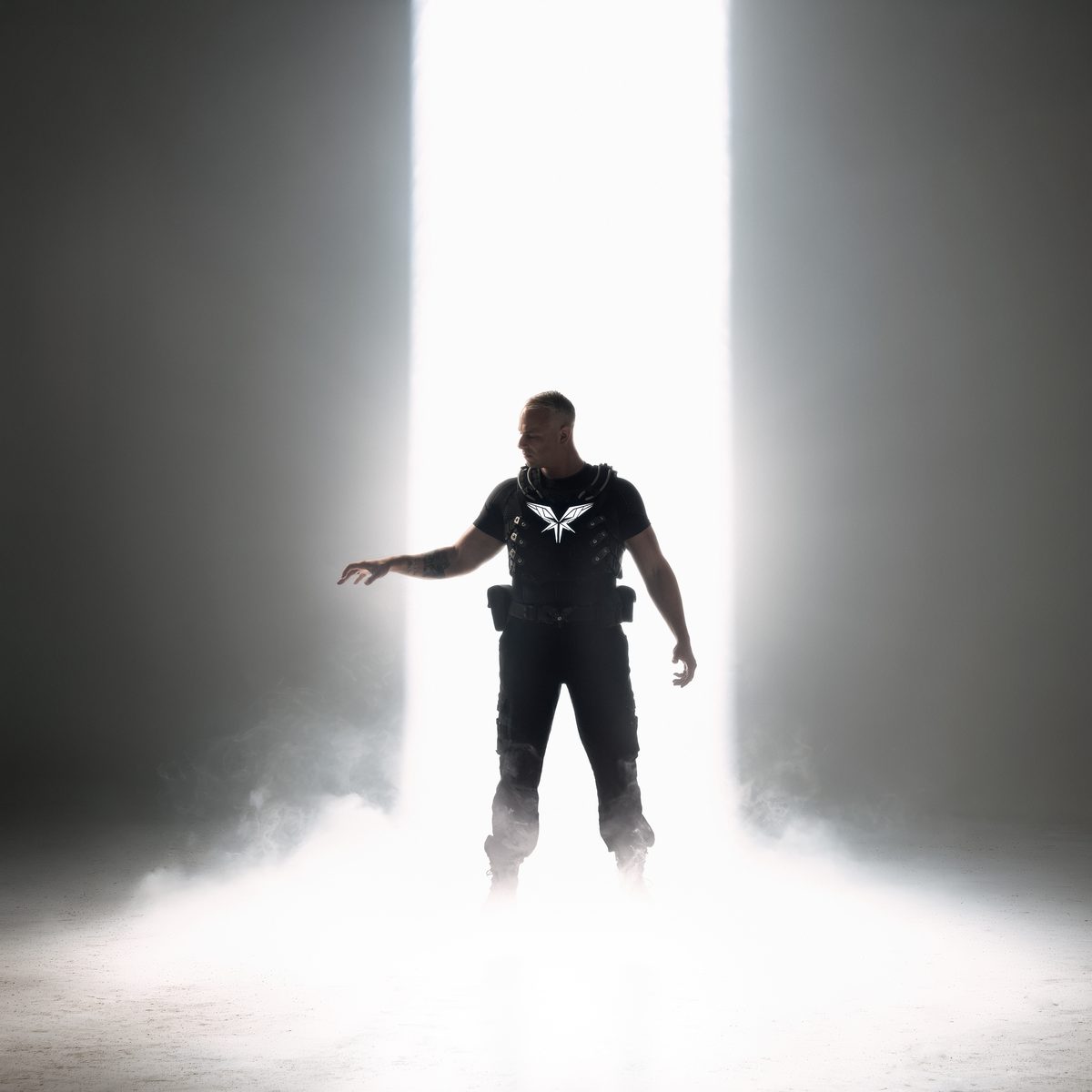 Radical Redemption standing in a shaft of light and fog
